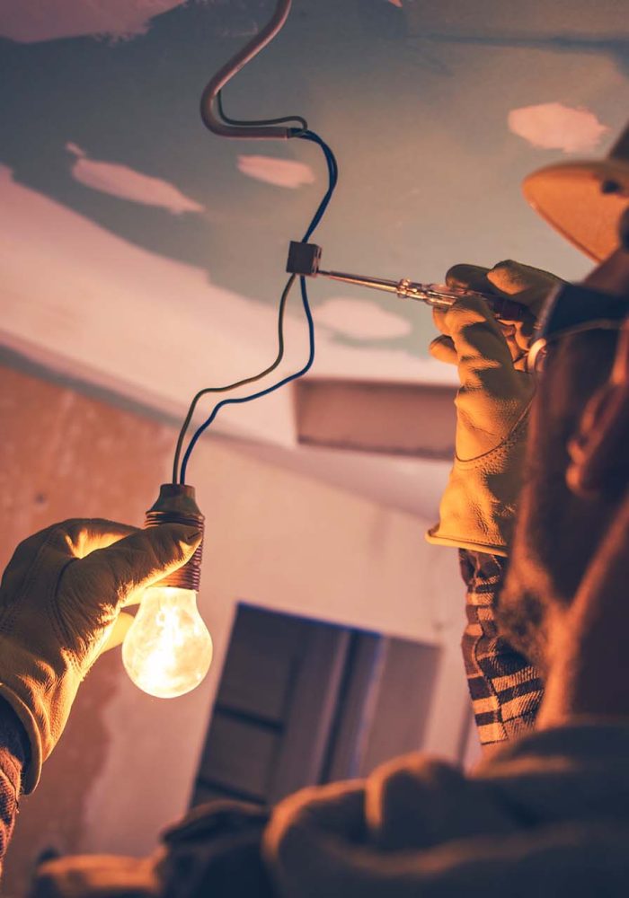 Working Contractor Electrician. Fixing the Light.